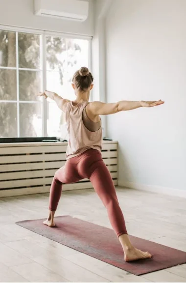 An image of a woman with Down Syndrome doing yoga with an Independent Living Specialist in Fresno, California